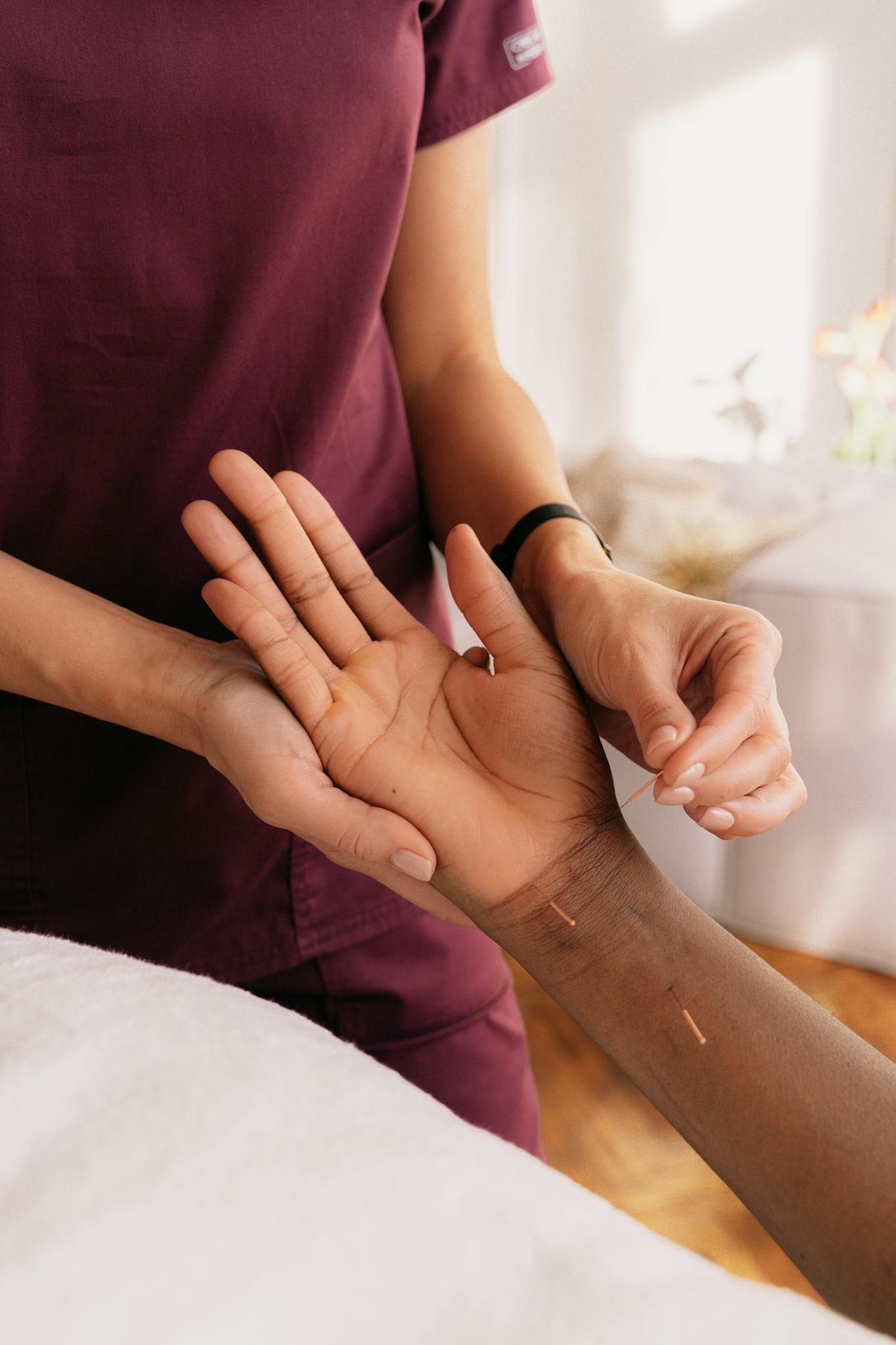 close up of hands performing acupuncture therapy on a patient in a spa setting. 6076142 1365x2048 1